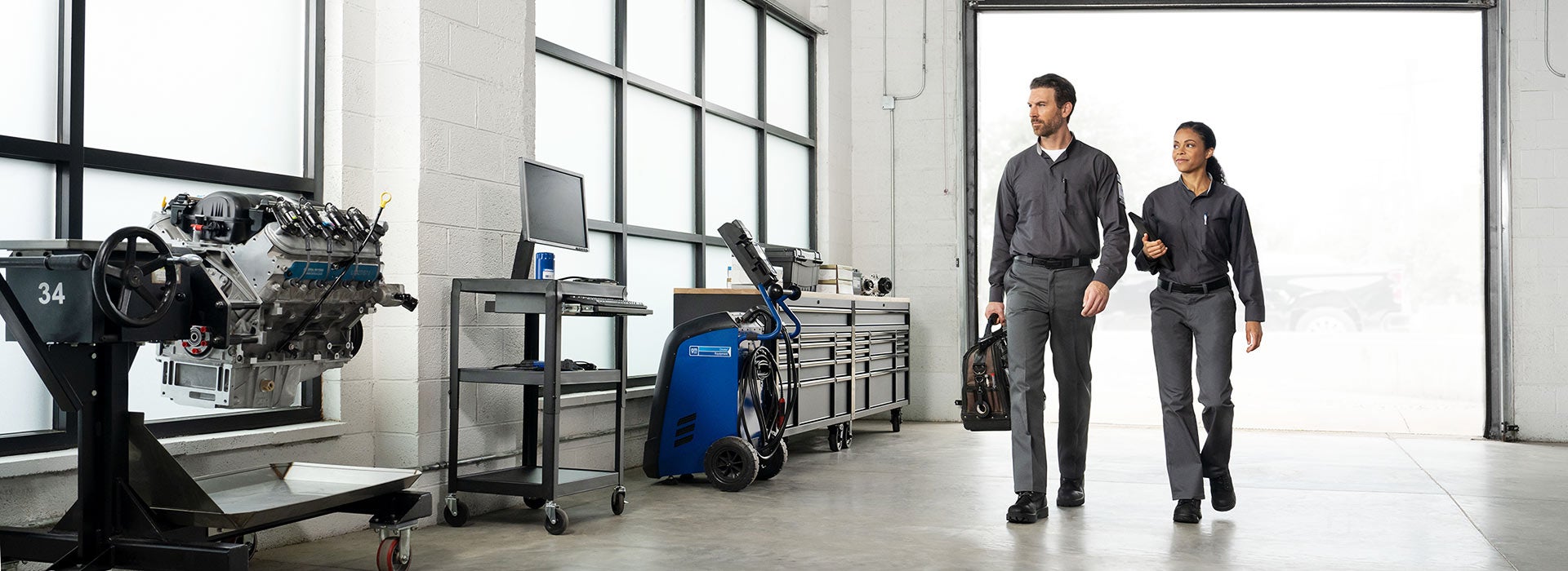 Chevrolet Certified Service technicians walking through a modern service workshop